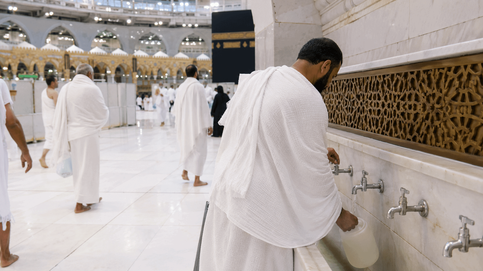 Muslim pilgrims perform Wudu at Masjid al-Haram in Mecca during Umrah.